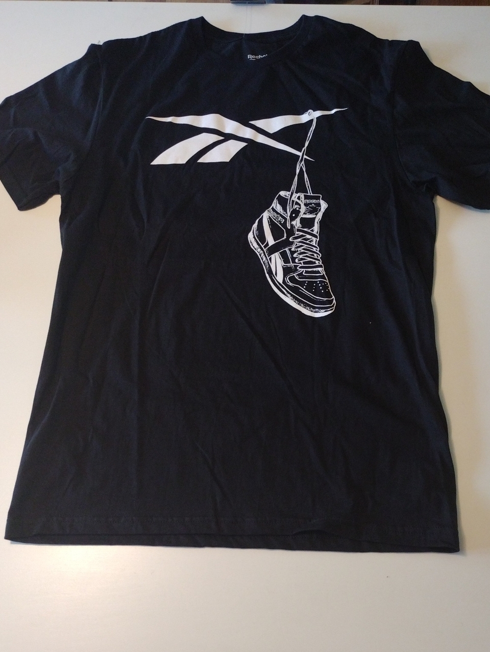 Reebok Black Tee with White Logo and Hanging Sneaker Graphic. (BOGO)
